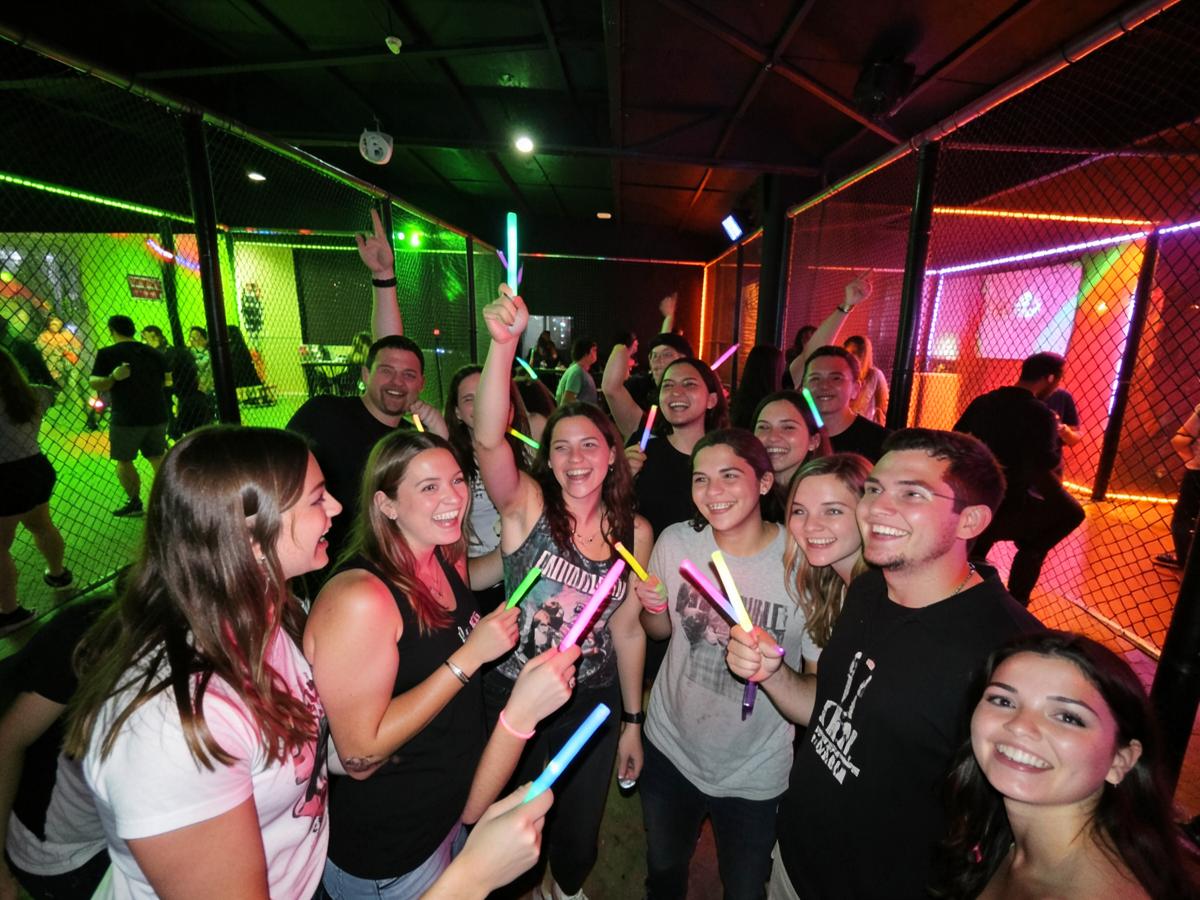 Friends celebrating at a glow-in-the-dark batting cage party